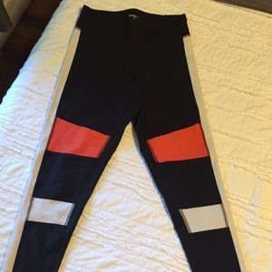 Black/orange/white Reebok leggings. Size Medium.